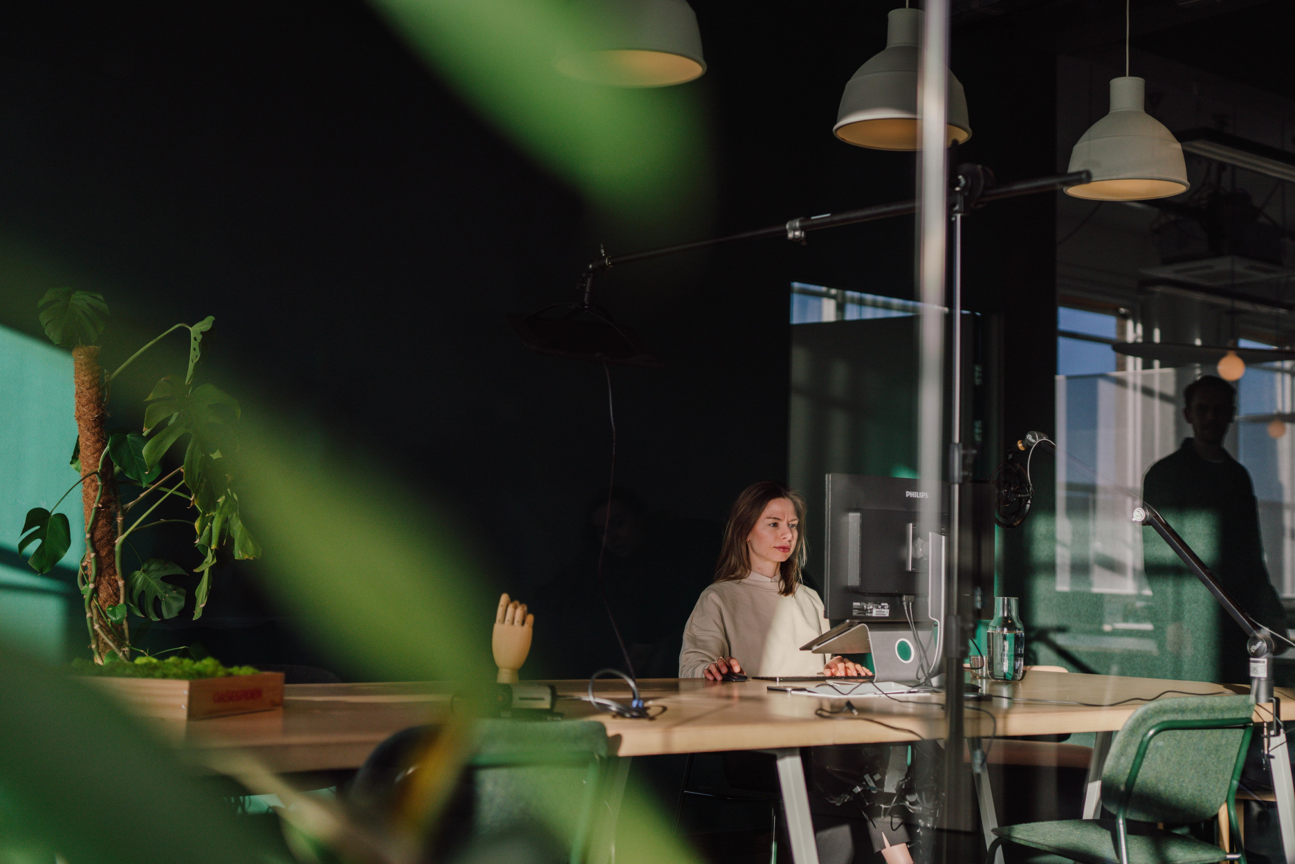 Justine de Bruijn focused on work at a desktop setup inside the Verve office workspace