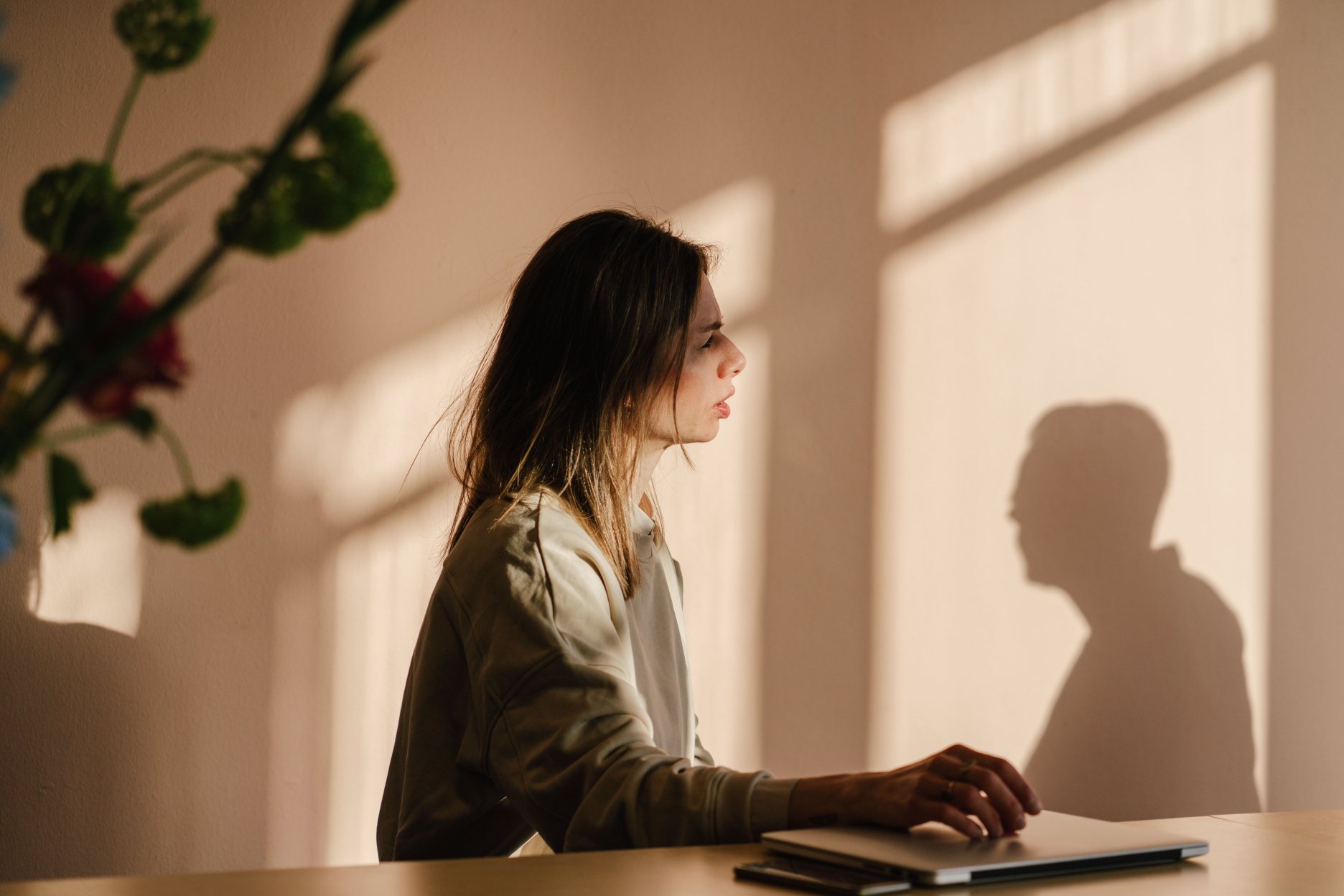 Side profile of Verve Head of Operations Justine de Bruijn seated at a desk with laptop