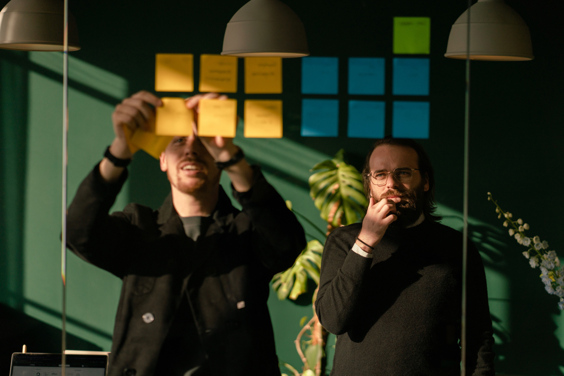 Romand and Giovanni placing post its on transparent board