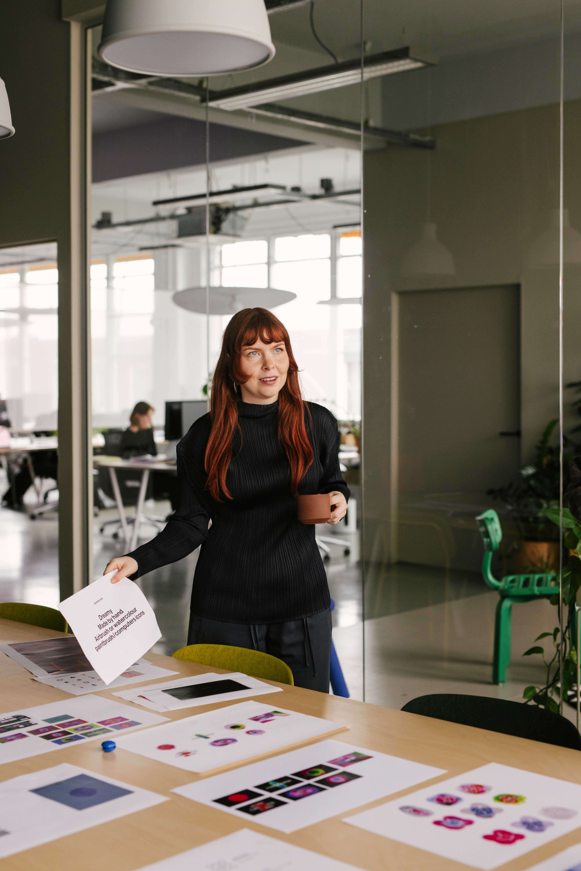 Sarah de Jager Lead Digital Design at Verve Agency reviewing brand refresh concepts at meeting table