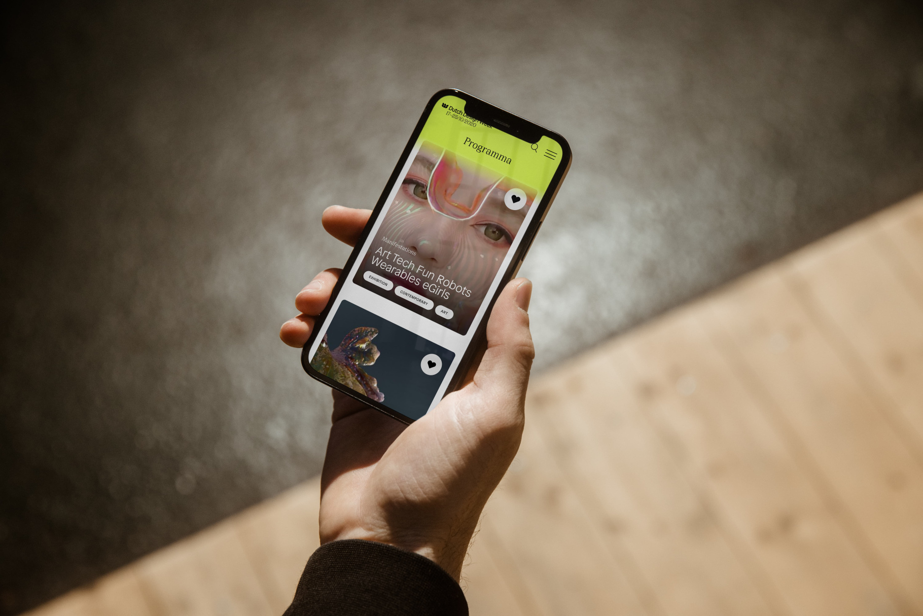 Dutch Design Week digital redesign - mobile app interface layout mockup held in hand