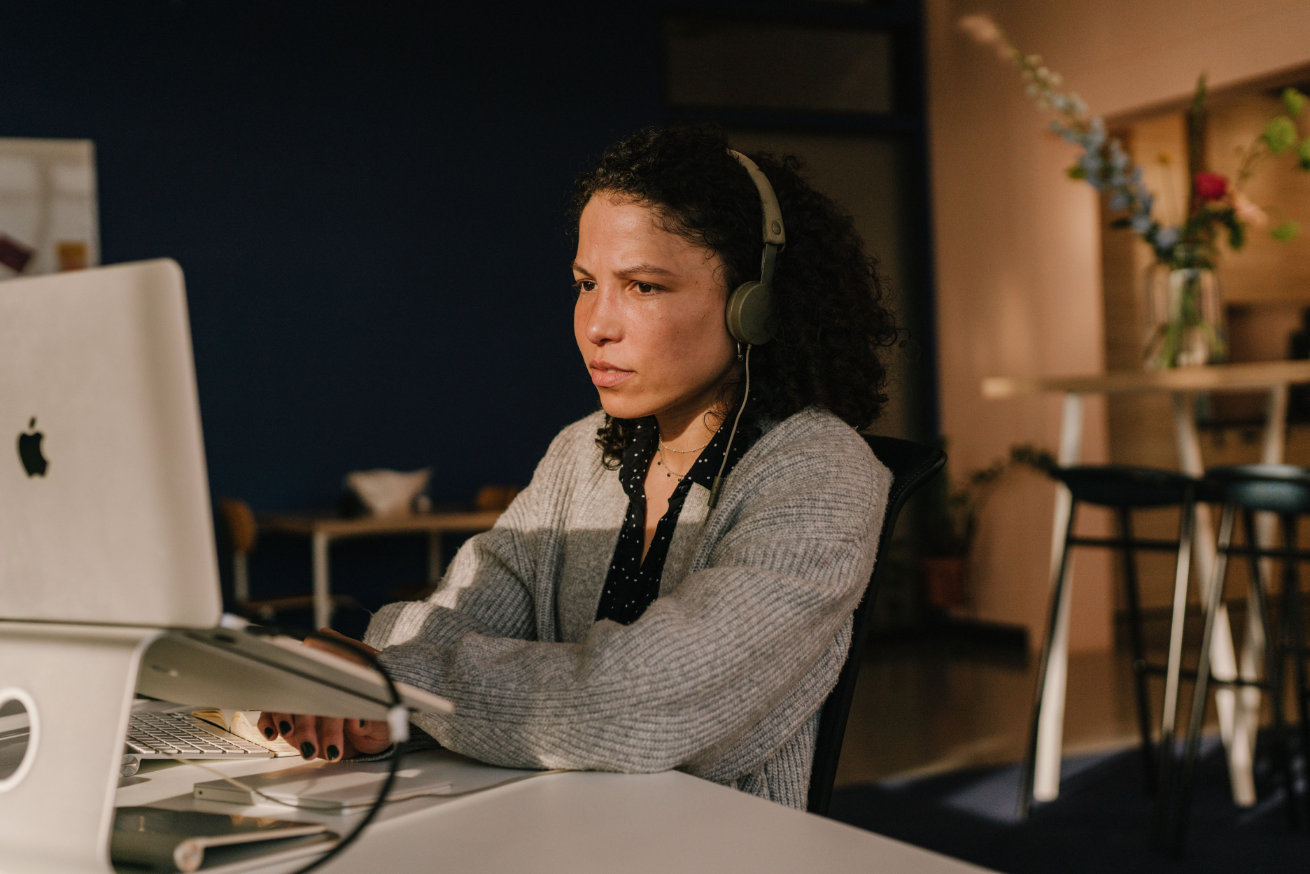 Yira working on her laptop with headphones on